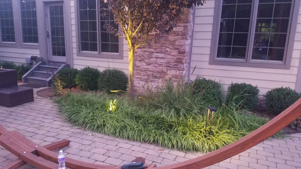 Foundation bed planted with shrubs and ornamental grasses by Lee's Lawn & Landscaping